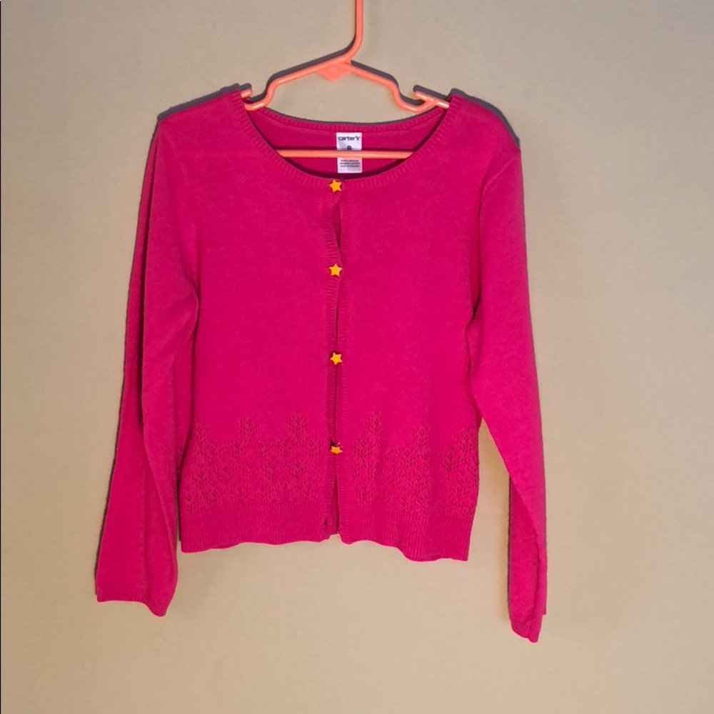 Hot pink cardigan with yellow star buttons